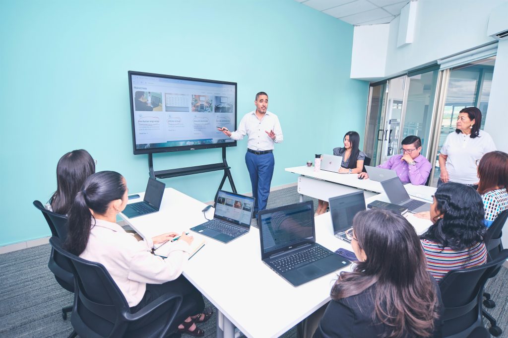 Team engaged in a presentation at a modern office using digital technology.